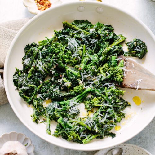 Olive oil and garlic sauteed broccoli rapini stems and florets in a skillet.