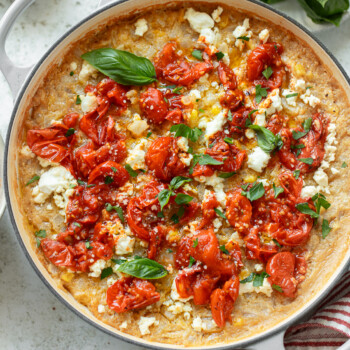 Roasted tomatoes, basil and goat cheese atop a skillet of baked polenta.